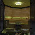Modern Sauna Interior Design With Wooden Seats Glass Door And Stove