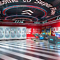 Trendy Play Playground With Red Walls Striped Flooring Neon Welcome And Power Zone