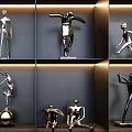 Modern Metal Sculptures In Various Poses On Indoor Display Shelves With Lighting