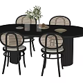 Black Round Dining Table Set With Rattan Backrest Chairs And Green Plant Centerpiece