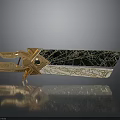 Ornate Golden Metal Decor With Black Cracked Surface Green Gem And Reflection Base