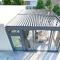 Modern Glass Sunroom With Metal Frame Dining Table And Surrounding Trees