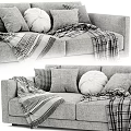 Cozy Two Seater Sofa with Plush Pillows and Checkered Blanket Accents