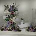 Decorative Floral Installation With Transparent Cylindrical Stands And Purple Pink White Flowers