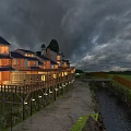 Ancient Architecture Lit Up with Warm Lights Alongside Countryside River and Fields