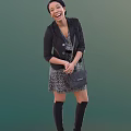 Woman Wearing Black Blazer Patterned Dress Chain Handbag and Knee High Boots on Green Background