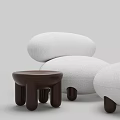 Plush White Rounded Lounger With Wooden Side Table And Cylindrical Legs