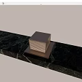 Square Illuminated Outdoor Light On Stone Slab Surface With Green Foliage