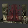 Iron Gate With Tree Design Between Stone Pillars And Green Plants