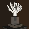 Coral Shaped Decorative Sculpture On Transparent Square Base With Warm Lighting And Brown Wall