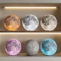 Colorful Moon Shaped Floor Lamps Display on Shelf With LED Strip Lighting