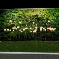 Decorative Floor Lamps with White Illuminated Lights in Front of Green Plant Wall on Grass