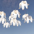 White Elephant Shaped Hanging Decorative Lights Against Blue Sky With Fluffy Clouds