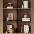 Decorative Ornaments Set On Wooden Shelf With Books And Glass Jars