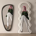 Mirrors With Black Irregular Shape And White Wavy Frame Against Light Wall With Potted Plant