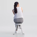 Woman Sitting On Chair Crossed Arms Wearing White Sleeveless Top Gray Leggings White Sneakers Smiling