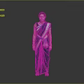 Woman In Green Saree With Blue Yellow Accents And Bangles Against Grey Background