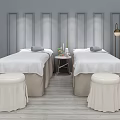 Two Massage Beds With White Sheets Stools Table Candles Plants Gray Wall Panels Floor Lamp