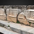 Ancient Stone Carved Architectural Elements With Intricate Floral And Geometric Motifs