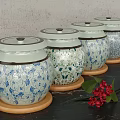 Ceramic Spice Jars With Blue And White Floral Patterns On Wooden Coasters