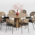Round Wooden Dining Table Set With Rattan Back Chairs Black Cushions Red Vase Pink Flowers