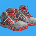 Gray High Top Athletic Shoes With Red Laces And Red White Stripes On Red Soles