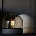 Modern Table Lamp With Black Glass Dome White Sphere And Glowing Visible Bulb