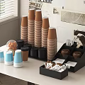 Blue And Brown Stacked Paper Cups With Coffee Lids Sugar Packets Stirrers On Organizer Table