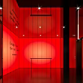Red Themed Interior Space With Text On Walls Lighting Dark Floor And Small Table 3d model