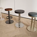 Modern Bar Stools With Various Colors And Metal Bases In Kitchen With Wooden Floor