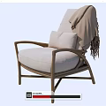 Comfortable Rattan Leisure Chair With Light Gray Cushion And Fringed Blanket For Cozy Home Use