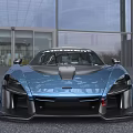McLaren Blue Sports Car With Aerodynamic Rear Wing And Sporty Exterior Design