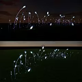 Outdoor Landscape Lights with Slender Poles and Glowing Spheres on Grass Lawn at Night