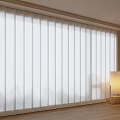 White Venetian Blinds Covering Window In Modern Living Room With Floor Lamp