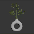 White Vase With Circular Hole Holding Green Branches In Simple Decor