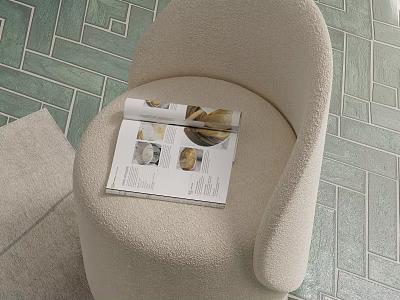Beige Plush Single Sofa with Open Magazine Featuring Shells on Green Geometric Patterned Floor 3d model