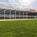 Modern Flower Market Building With Glass Structure Green Lawn And Red Signage