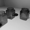 Three Transparent Square Storage Jars with Lids One with Handle and Lid Placed Aside