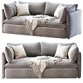 Two Seater Gray Fabric Sofa With Decorative Pillows And Fringed Blanket