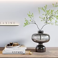 Relaxing Decorative Ornament Set Featuring Glass Vase Green Foliage Books and Wooden Tabletop