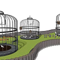 Round Metal Birdcages With Birds On Green Grass Lawn And Fence