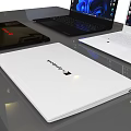 Three Modern Black And White Laptops With Blue Abstract Screens On Table