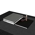 Decorative Ornament Set With White Covered Books Metal Ring Cube And Candle On Black Tabletop