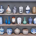 Various Ceramic Vessels Displayed On Wooden Shelves With Blue And White Patterns And Different Shapes