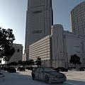 Modern Office Building With Tall Glass Facade And Cylindrical Structure Near Street Trees And Cars