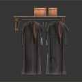 Dark Colored Clothes With Brown Decorations Hanging On Wooden Shelf With Baskets