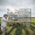 Golden Event Display Wall with China Overseas Text City Skyline Silhouette and Person Taking