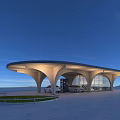 Modern EV Charging Station With Curved Roof White Structure And Blue Sky