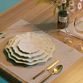 White Scalloped Dinnerware Set with Stacked Plates Cutlery Wine Glasses Linen Placemat on Wooden Table