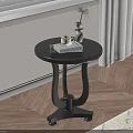 Black Round Side Table with Books Coffee Cup and Vase in Wooden Floor Interior